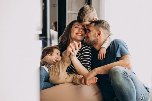 young-family-with-their-sons-home-having-fun_1303-20999